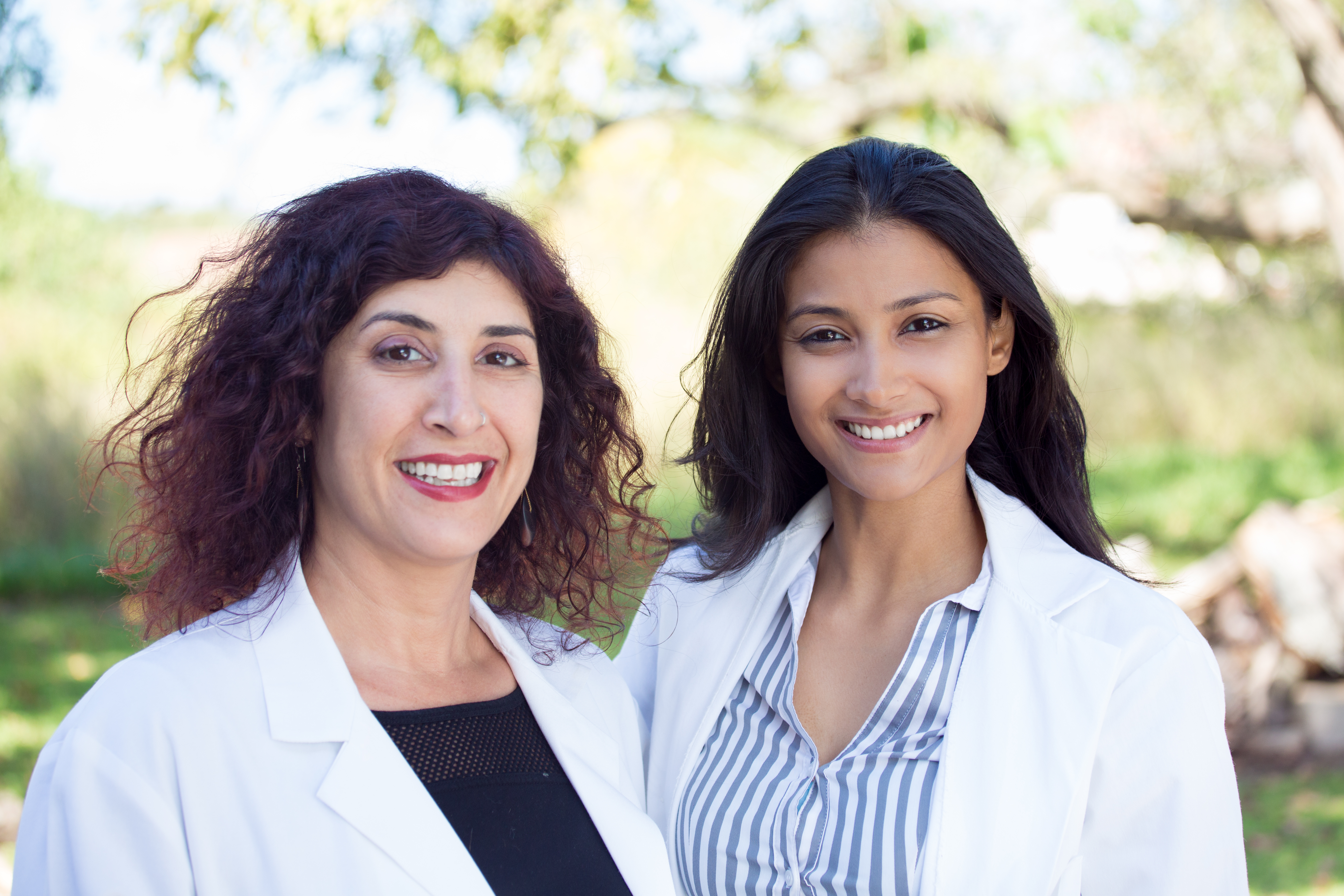 Two individuals in white coats